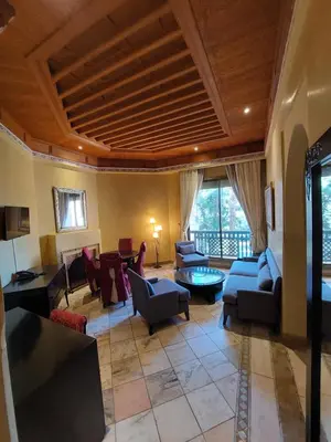a living room with couches chairs and a table at Palmeraie Village in Marrakech