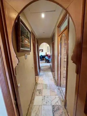 a hallway with an archway in a house at Palmeraie Village in Marrakech