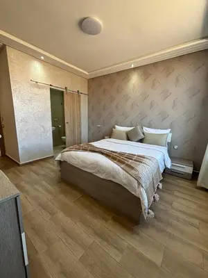 a bedroom with a large bed in a room at Riad L'Aéroport in Marrakech