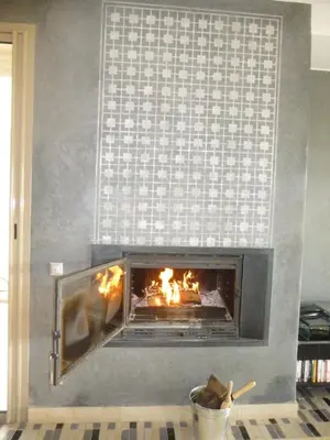 a fireplace with a fire burning in it at Villa Firdaous in Marrakech