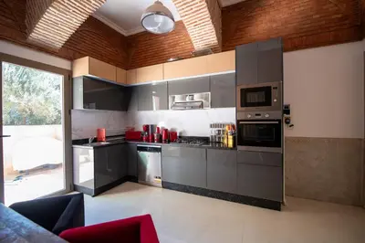 a kitchen with gray cabinets and a large window at Villa Cartier in Marrakech