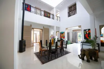 a dining room and living room with an elephant in the middle at Villa Cartier in Marrakech