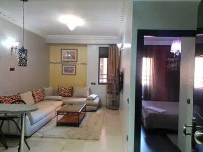 a living room with a couch and a table at Central Aparts Av Prince Moulay Abdellah in Marrakech