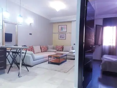 a living room with a couch and a table at Central Aparts Av Prince Moulay Abdellah in Marrakech