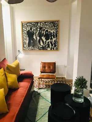 a living room with a couch and a chair at Riad-Shakho-Marrakech in Marrakech