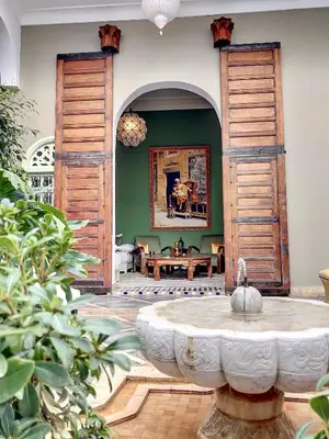 a living room with a fountain in the middle of a room at Riad Dar Chacha in Marrakech