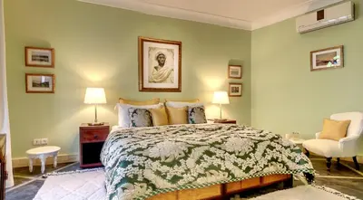 a bedroom with a bed and two lamps and a chair at Riad Dar Chacha in Marrakech