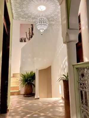 a hallway with a chandelier in a building at Riad Dar Chacha in Marrakech