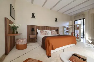 a bedroom with a large bed and a table at Villa Dar Challa in Marrakech