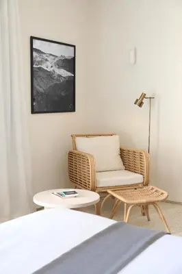 a room with a bed and a chair and a table at Villa Dar Challa in Marrakech