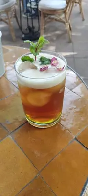 a drink on a glass table with a plant in it at Beldicolors in Marrakech