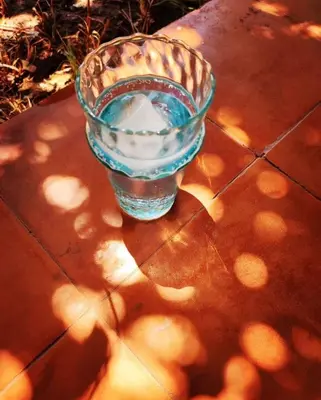 a glass of water sitting on top of a table at Beldicolors in Marrakech