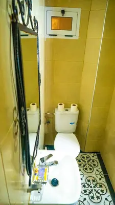 a bathroom with a toilet and a sink and a mirror at Hotel imouzzer in Marrakech