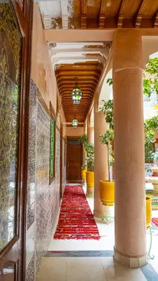 a hallway with a red carpet in a building at Hotel imouzzer in Marrakech