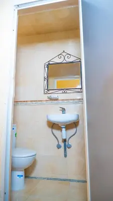 a bathroom with a sink and a mirror on the wall at Hotel imouzzer in Marrakech