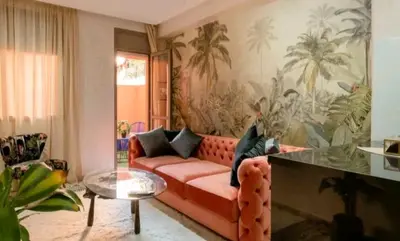 a living room with a red couch and a glass table at The Best location to visit Marrakech Carré Eden a little Walk to the Médina in Marrakech