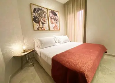 a bedroom with a large bed with a red blanket at The Best location to visit Marrakech Carré Eden a little Walk to the Médina in Marrakech