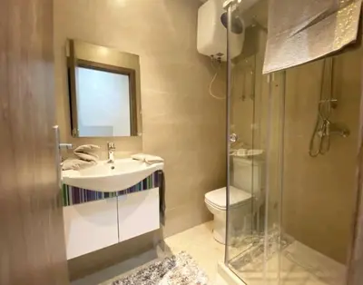 a bathroom with a sink and a toilet and a mirror at The Best location to visit Marrakech Carré Eden a little Walk to the Médina in Marrakech