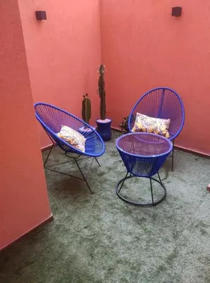 two blue chairs in a room with red walls at The Best location to visit Marrakech Carré Eden a little Walk to the Médina in Marrakech