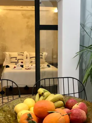 a bowl of fruit on a table in a room at Riad Oscaroi in Marrakech