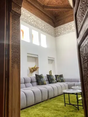 a living room with a large couch in a room at Riad Oscaroi in Marrakech