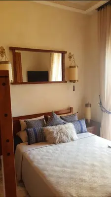 a bedroom with a large bed with a large mirror at marrakech palmeraie village Etablissement jasmin in Marrakech