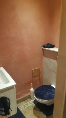 a bathroom with a blue toilet and a sink at marrakech palmeraie village Etablissement jasmin in Marrakech