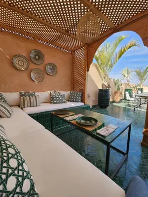 a living room with a couch and a table at Riad Le Saadien ,Adult only in Marrakech
