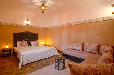 a bedroom with a bed and a couch at Riad Basim in Marrakech