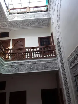a balcony in a building with a ceiling at Riad Nouhal in Marrakech