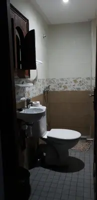 a bathroom with a toilet and a sink at Riad Nouhal in Marrakech