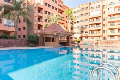 a swimming pool in front of a building at diamant Marrakech centre in Marrakech