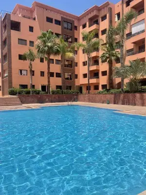 a large swimming pool in front of a building at diamant Marrakech centre in Marrakech