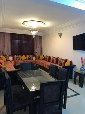 a living room with a couch and a table at diamant Marrakech centre in Marrakech