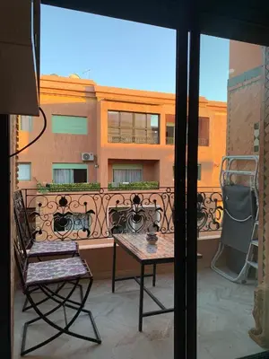 a view of a balcony with a table and a chair at diamant Marrakech centre in Marrakech