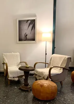 a room with two chairs and a table and a lamp at Riad Ksar Saad & Spa in Marrakech