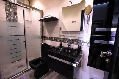 a bathroom with a sink and a toilet and a mirror at Le soleil de Marrakech in Marrakech