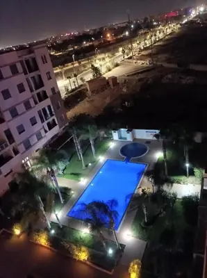 an overhead view of a swimming pool at night at Le soleil de Marrakech in Marrakech