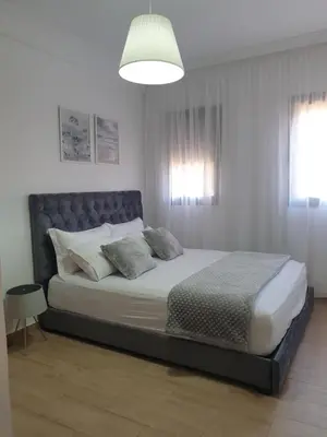 a bedroom with a large bed in a room at Apparemment yasmina in Marrakech