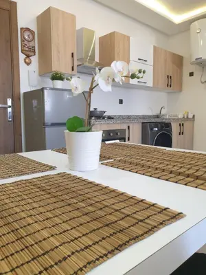 a kitchen with a table with a plant on it at Apparemment yasmina in Marrakech