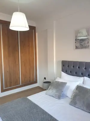 a bedroom with a bed and a large window at Apparemment yasmina in Marrakech