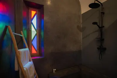 a bathroom with a stained glass window and a tub at Riad Tassili Marrakech in Marrakech