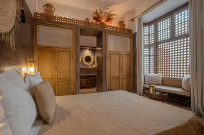 a bedroom with a bed and a large window at Riad Tassili Marrakech in Marrakech
