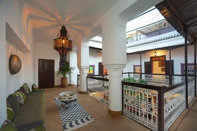 a living room with a couch and a chandelier at Dar Le Fennec in Marrakech