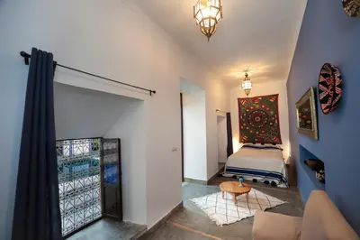 a bedroom with a bed and a painting on the wall at Dar Le Fennec in Marrakech