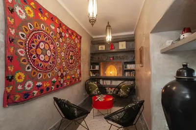 a room with chairs and a large painting on the wall at Dar Le Fennec in Marrakech