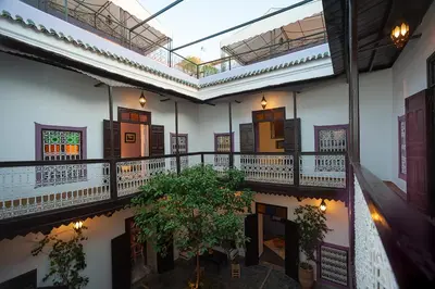 an empty building with a plant on a balcony at Dar Le Fennec in Marrakech