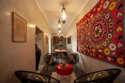 a room with chairs and a painting on the wall at Dar Le Fennec in Marrakech