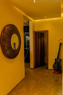 a room with a mirror and a guitar on a wall at Villa des sœurs bradaa in Marrakech