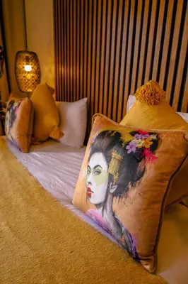 a bed with a blanket with a woman on it at Villa des sœurs bradaa in Marrakech